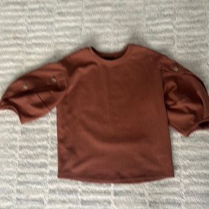 Anthropologie brown shirt with unique bell sleeves.